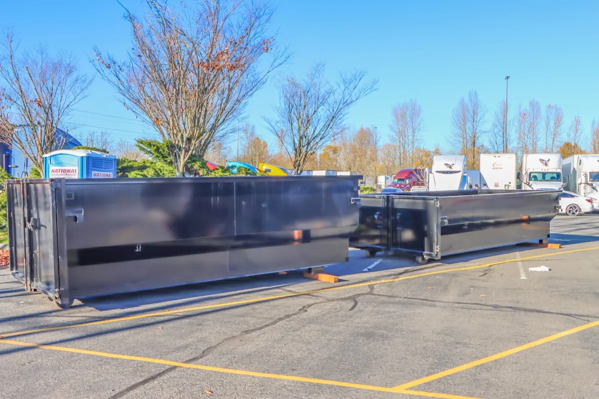 Professional dumpster rental service with roll-off container on residential driveway in Gloucester